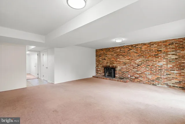 a view of an empty room with brick walls