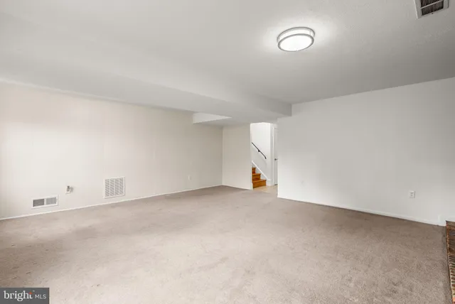 an empty room with a white walls and cabinets