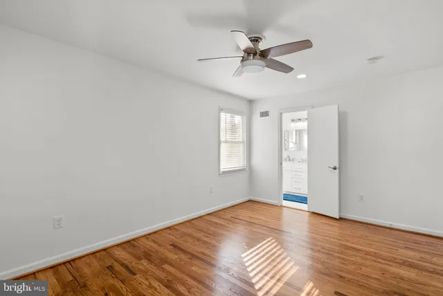 a view of room with wooden floor and windows