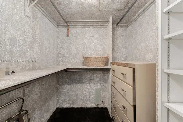 a bathroom with a granite countertop shower sink vanity and toilet