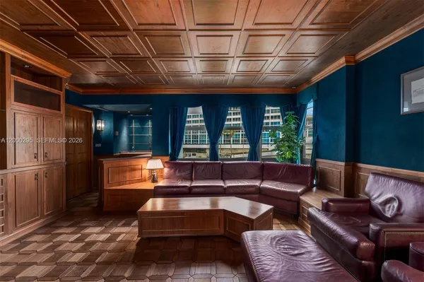 a view of a street with a cars parked and a park