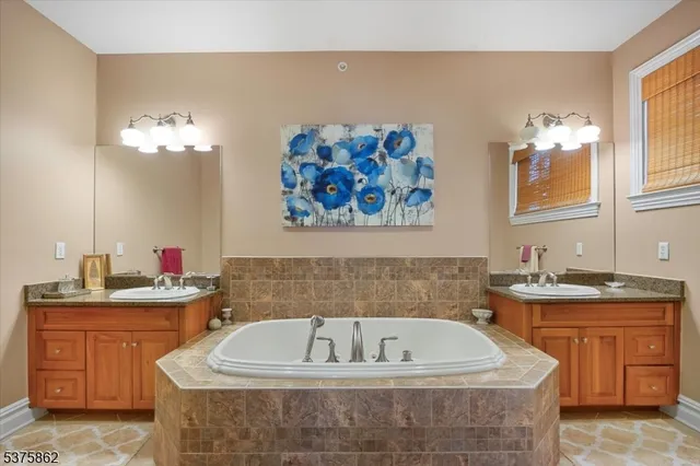 a bathroom with a tub sink and shower