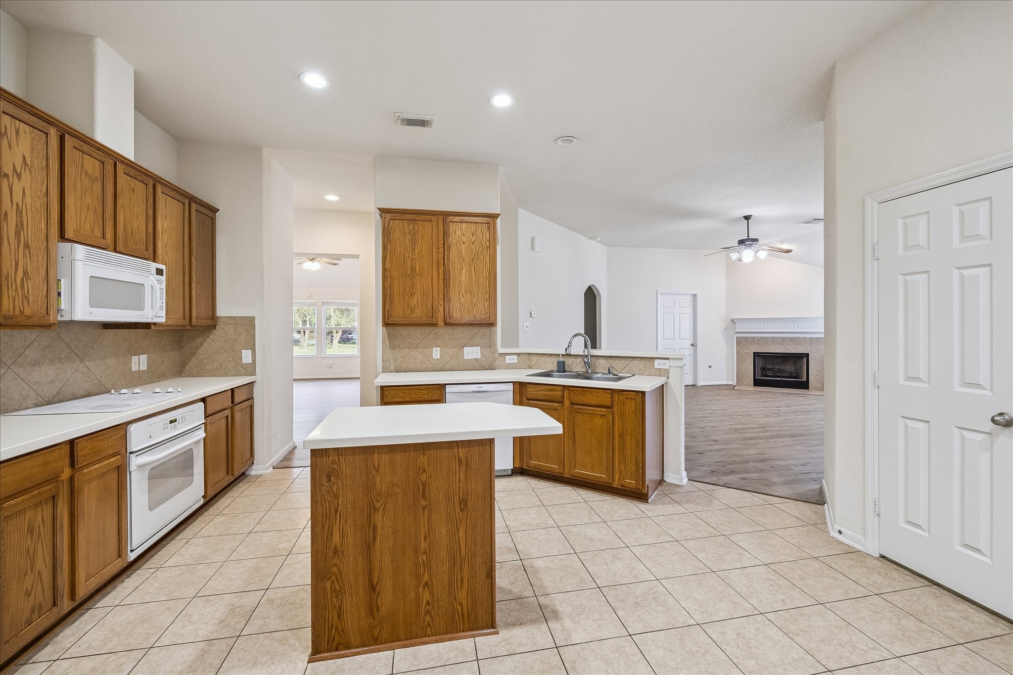 19403 Valiant Woods Drive Spring, TX 77379 - Photo 15 of 42 The kitchen flows effortlessly into the family room, creating one connected space where life naturally gathers. Expansive counter space gives you plenty of room for meal preparation.