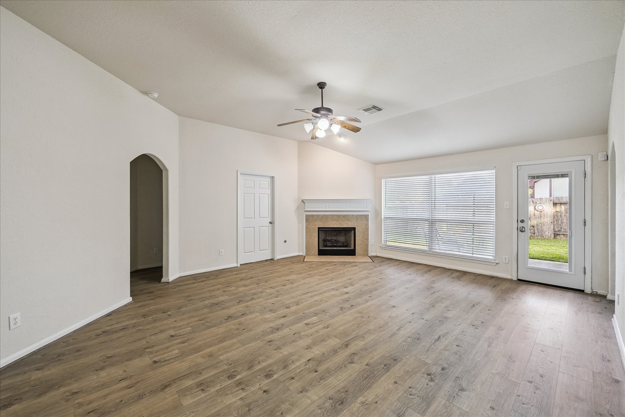 19403 Valiant Woods Drive Spring, TX 77379 - Photo 16 of 42 a view of an empty room with a fireplace and a window