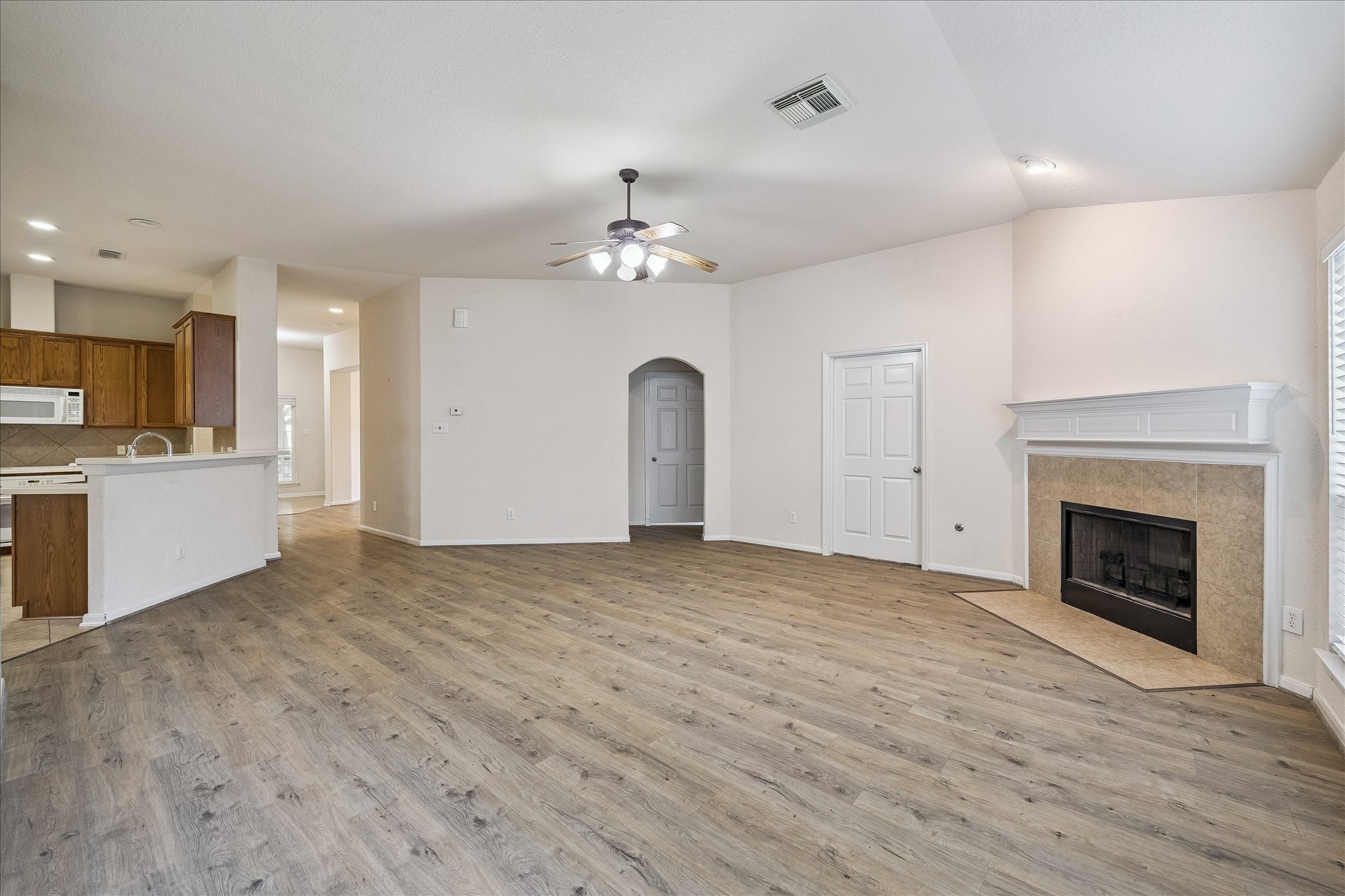 19403 Valiant Woods Drive Spring, TX 77379 - Photo 18 of 42 a view of a kitchen with a sink and a fireplace