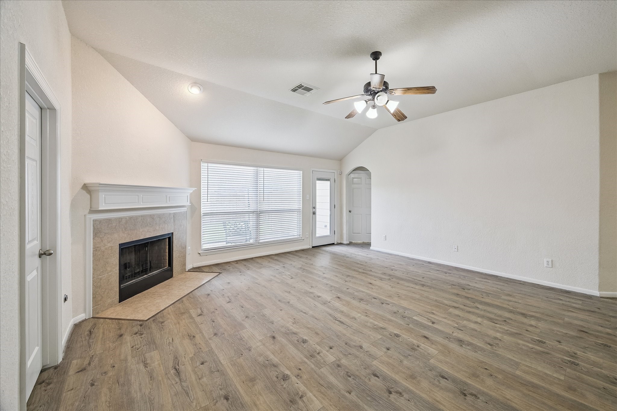 19403 Valiant Woods Drive Spring, TX 77379 - Photo 20 of 42 a view of empty room with wooden floor and fireplace