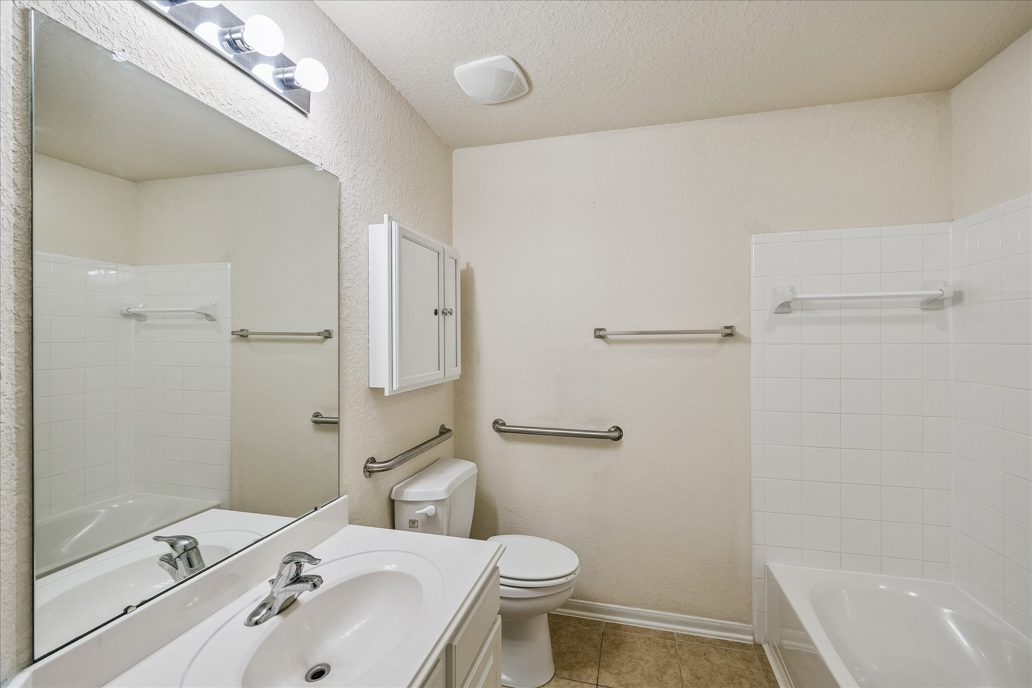 19403 Valiant Woods Drive Spring, TX 77379 - Photo 25 of 42 a bathroom with a sink toilet and shower