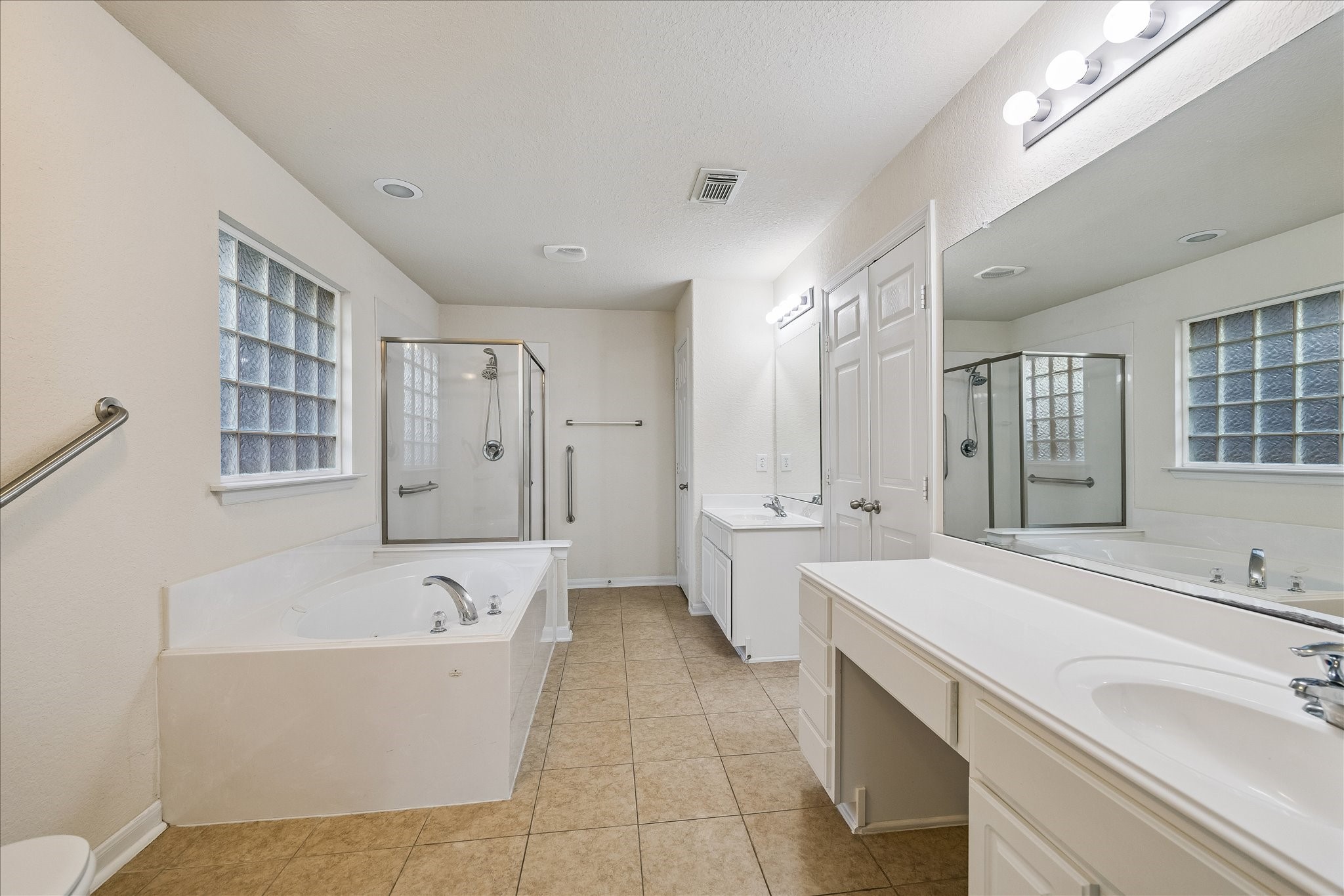 19403 Valiant Woods Drive Spring, TX 77379 - Photo 28 of 42 The ensuite bath elevates the experience with gleaming countertops, dual sinks, a glass shower, and a jetted soaking tub that calls for long, relaxing evenings.