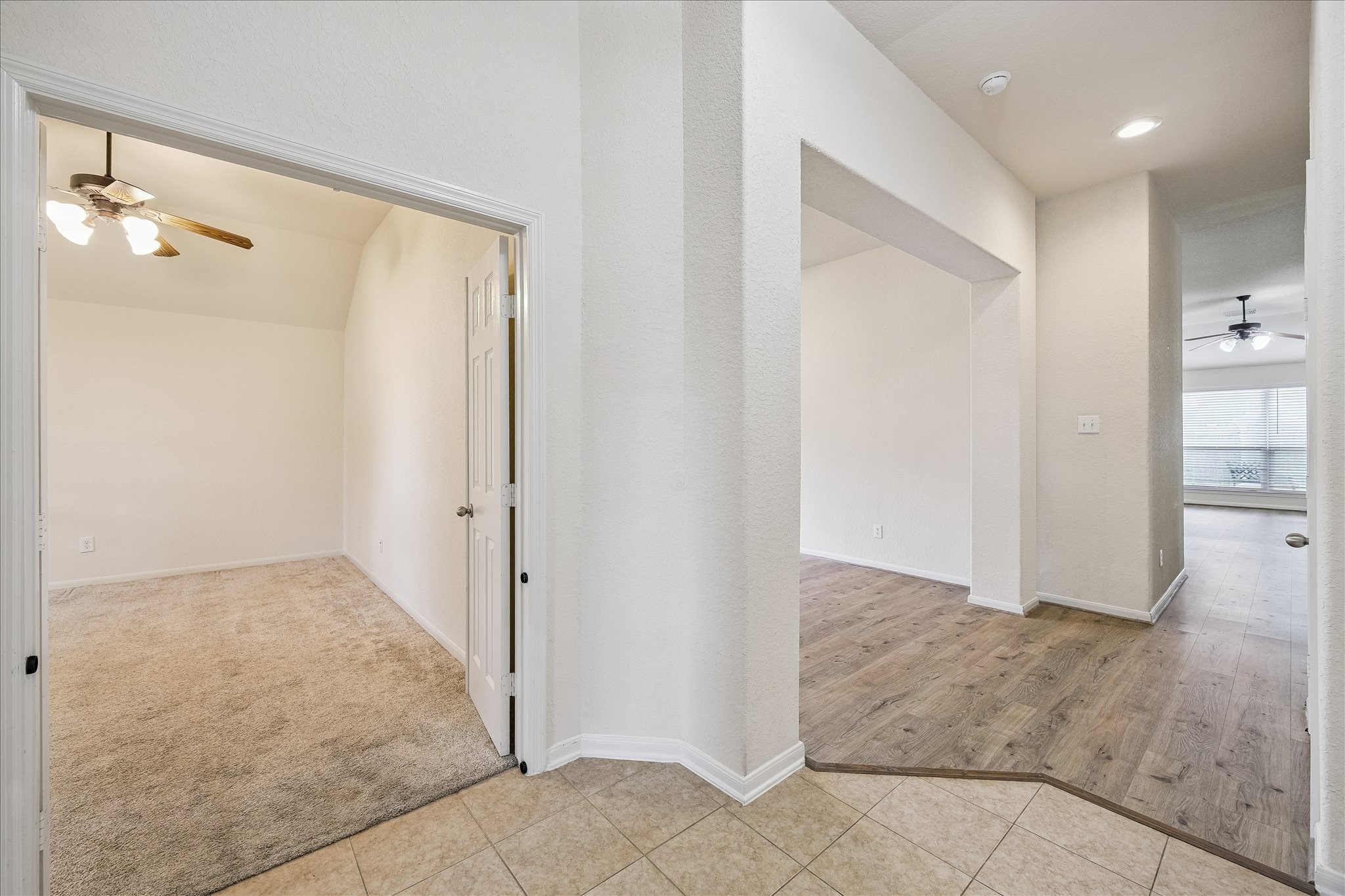 19403 Valiant Woods Drive Spring, TX 77379 - Photo 3 of 42 an empty room with wooden floor and a bathroom