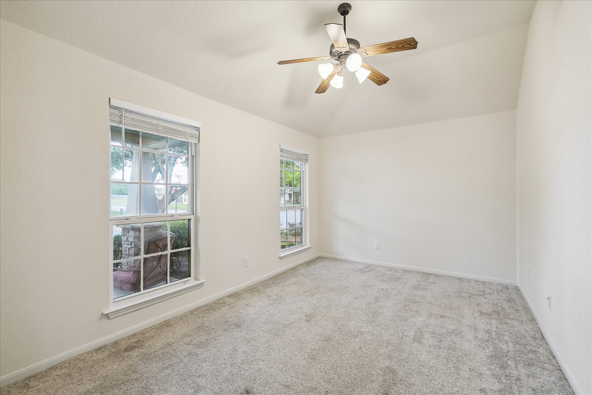 19403 Valiant Woods Drive Spring, TX 77379 - Photo 4 of 42 an empty room with windows and fan