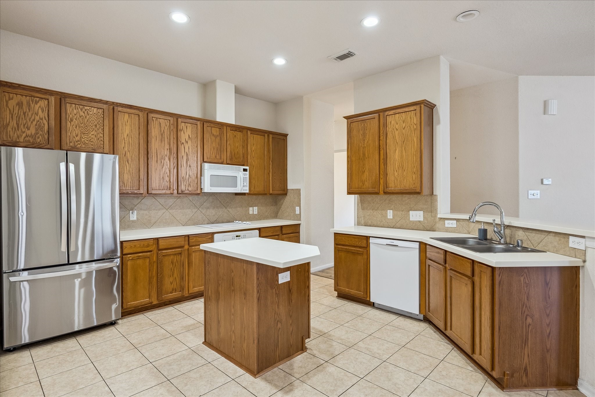 19403 Valiant Woods Drive Spring, TX 77379 - Photo 10 of 42 a kitchen with a sink stove and refrigerator