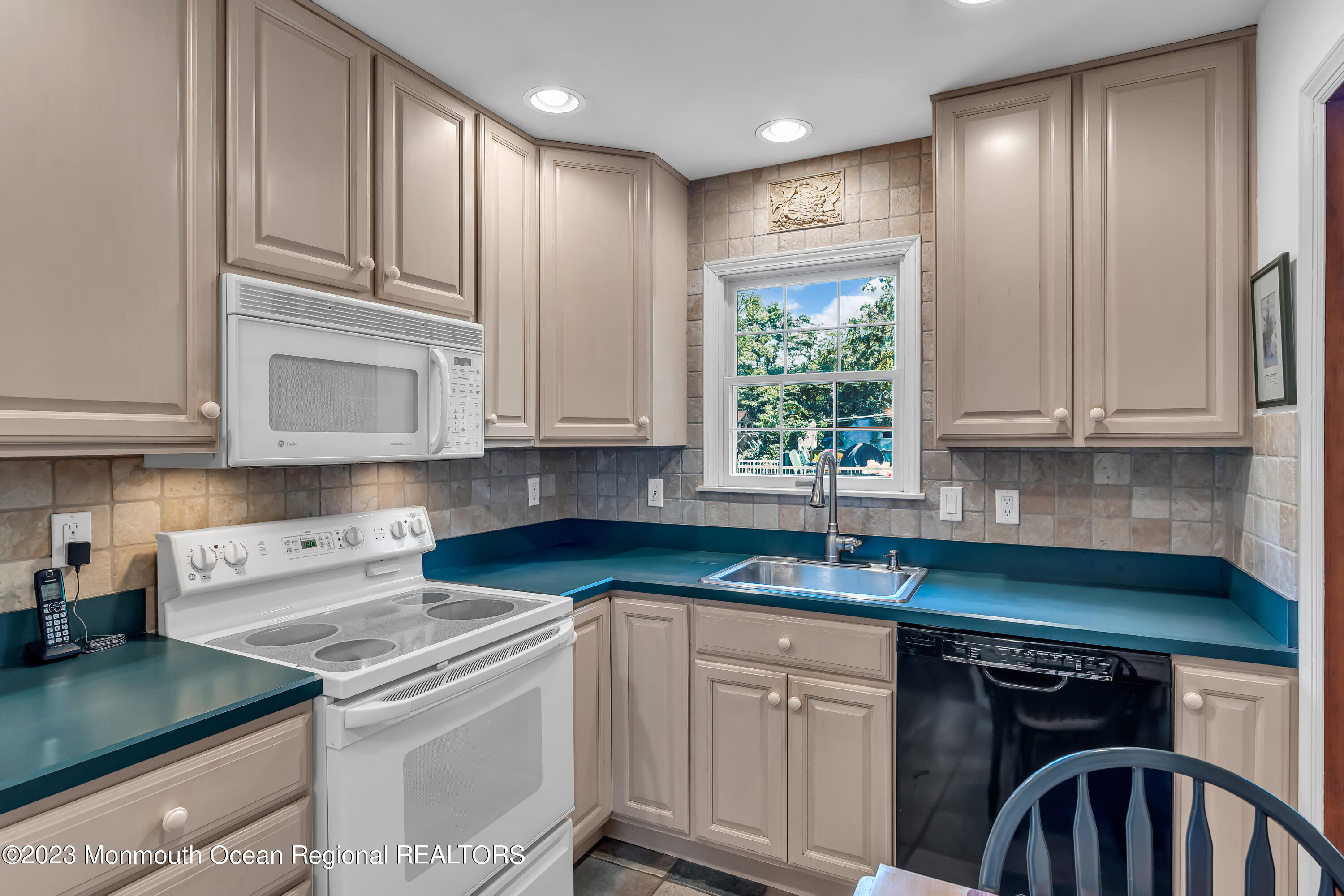 41 Citadel Drive Jackson, NJ 08527 - Photo 17 of 46 a kitchen with stainless steel appliances granite countertop a stove a sink and white cabinets