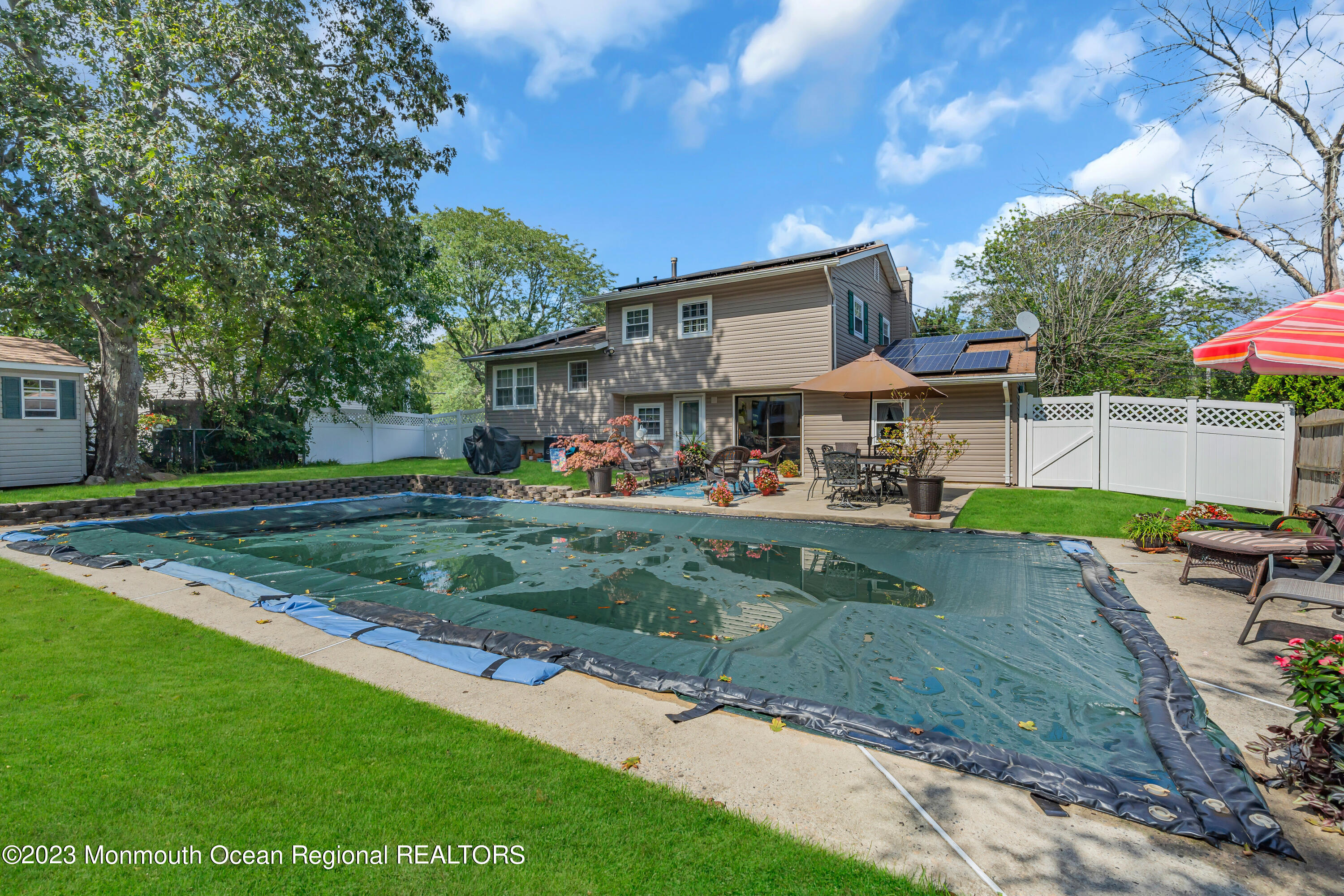 41 Citadel Drive Jackson, NJ 08527 - Photo 39 of 46 a view of a yard with table and chairs under an umbrella