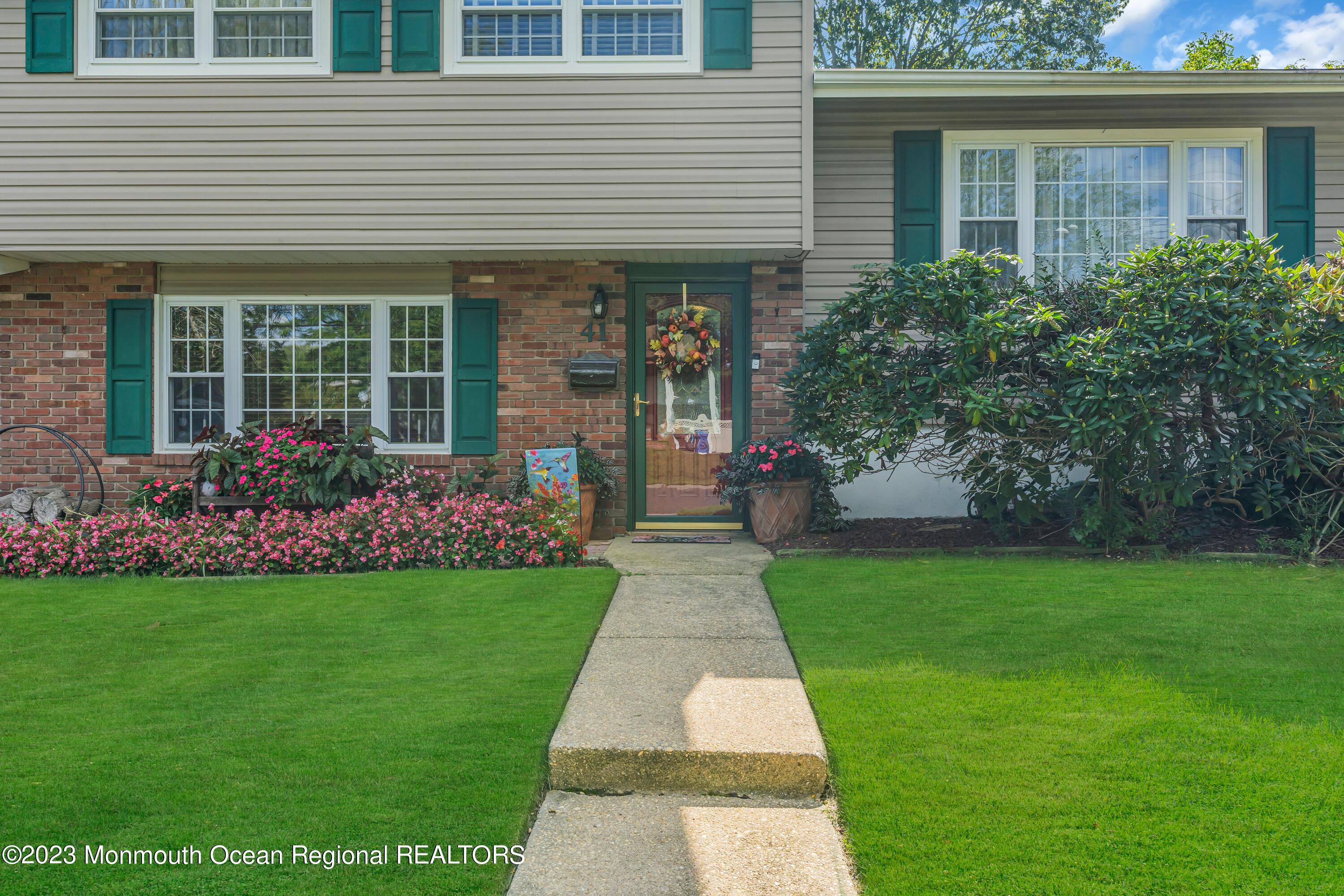 41 Citadel Drive Jackson, NJ 08527 - Photo 7 of 46 a front view of a house with a garden and plants