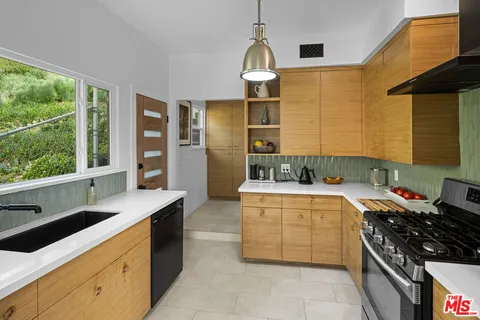 a kitchen with a stove and a sink