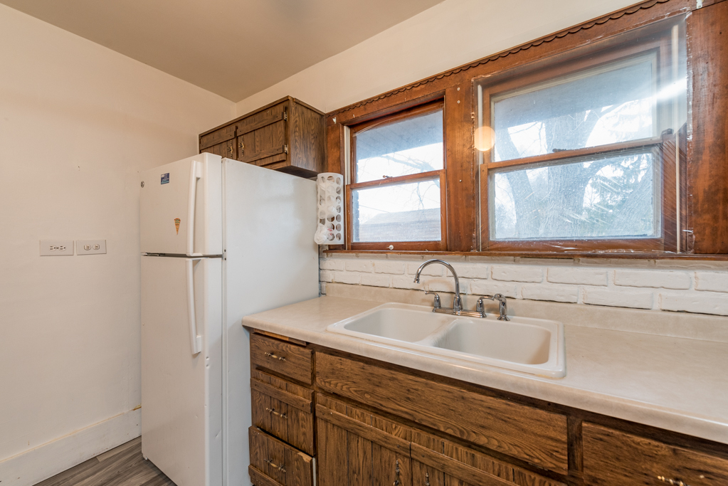 604 North Oplaine Road Waukegan, IL 60085 - Photo 13 of 31 a bathroom with a sink and a mirror