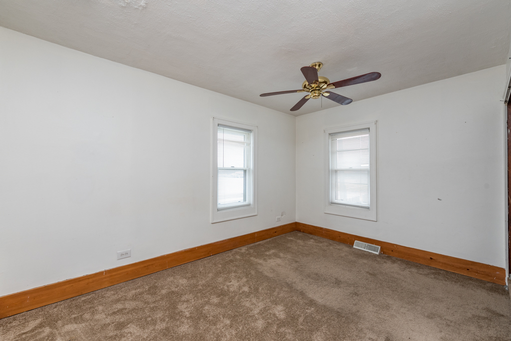 604 North Oplaine Road Waukegan, IL 60085 - Photo 14 of 31 an empty room with fan and windows