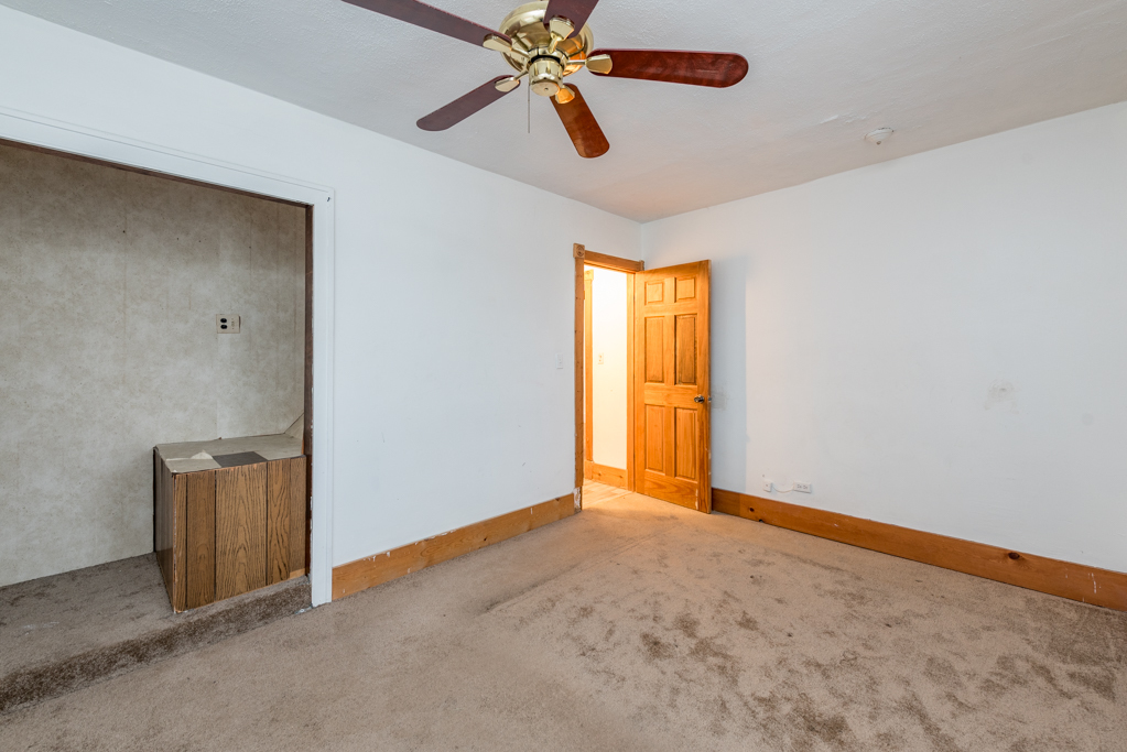 604 North Oplaine Road Waukegan, IL 60085 - Photo 15 of 31 an empty room with closet and chandelier fan