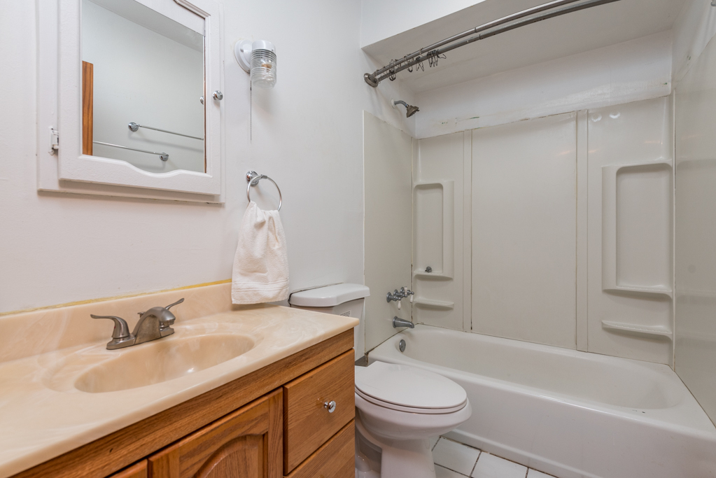 604 North Oplaine Road Waukegan, IL 60085 - Photo 18 of 31 a bathroom with a sink toilet tub and shower