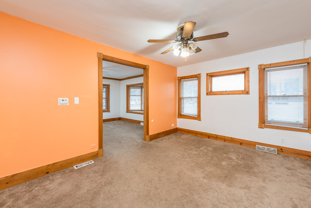 604 North Oplaine Road Waukegan, IL 60085 - Photo 5 of 31 an empty room with chandelier fan and windows
