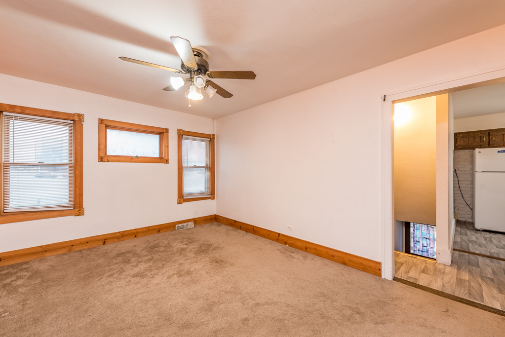 604 North Oplaine Road Waukegan, IL 60085 - Photo 6 of 31 an empty room with windows and fan