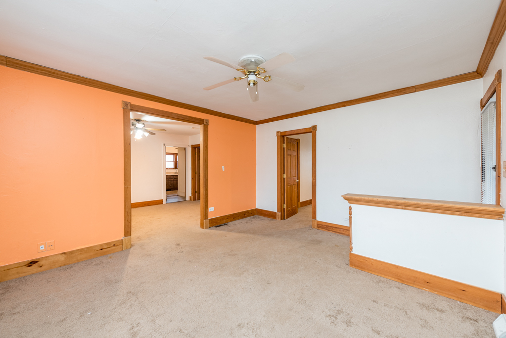 604 North Oplaine Road Waukegan, IL 60085 - Photo 9 of 31 an empty room with chandelier fan and windows
