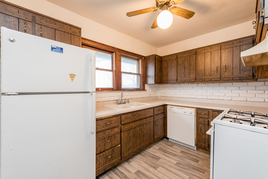 604 North Oplaine Road Waukegan, IL 60085 - Photo 10 of 31 a kitchen with a sink cabinets and window