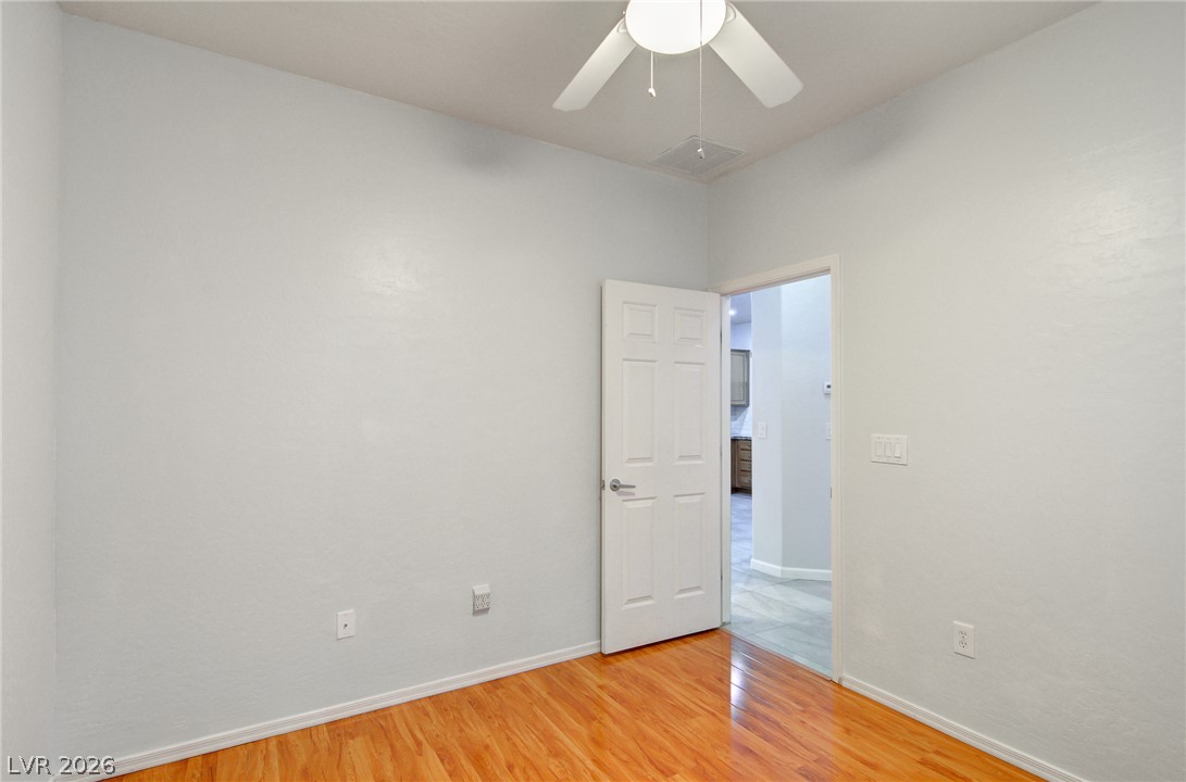 2339 Tranquil Moon Street Henderson, NV 89044 - Photo 14 of 15 Warm wood flooring grounds this versatile space, perfect as an office or bedroom.
