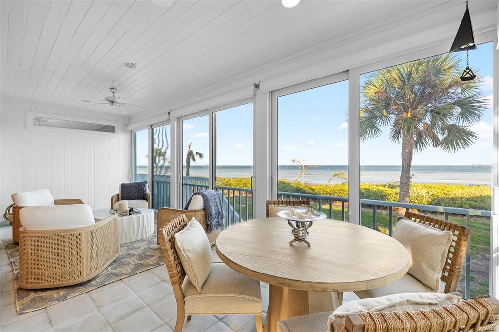 319 Pilot Point Lane Boca Grande, FL 33921 - Photo 16 of 62 a dining room with furniture water view and a floor to ceiling window