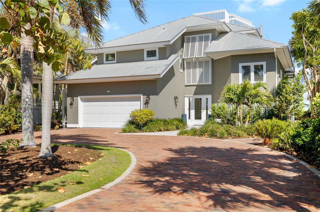 319 Pilot Point Lane Boca Grande, FL 33921 - Photo 2 of 62 a front view of a house with a garden and plants
