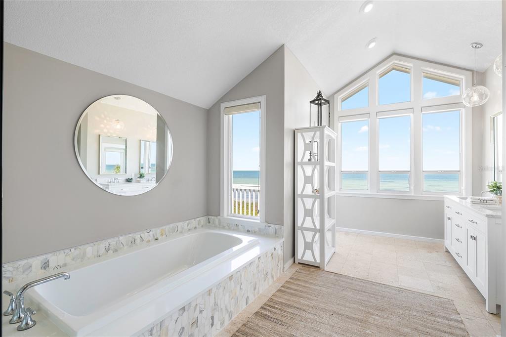 319 Pilot Point Lane Boca Grande, FL 33921 - Photo 22 of 62 a spacious bathroom with a bathtub and a large window