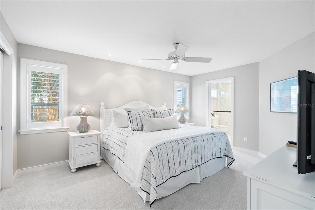 319 Pilot Point Lane Boca Grande, FL 33921 - Photo 31 of 62 a bedroom with a large bed a flat tv screen and a dresser