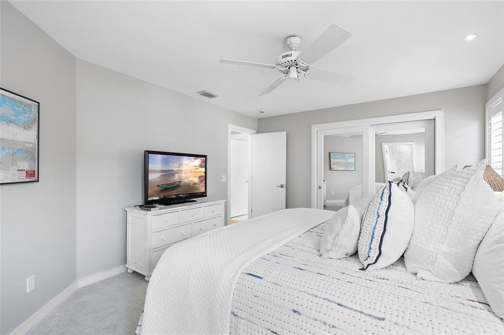 319 Pilot Point Lane Boca Grande, FL 33921 - Photo 32 of 62 a bedroom with a bed and a flat screen tv