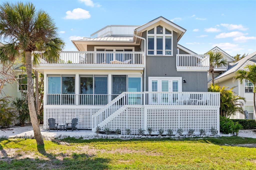 319 Pilot Point Lane Boca Grande, FL 33921 - Photo 46 of 62 a front view of a house with a yard