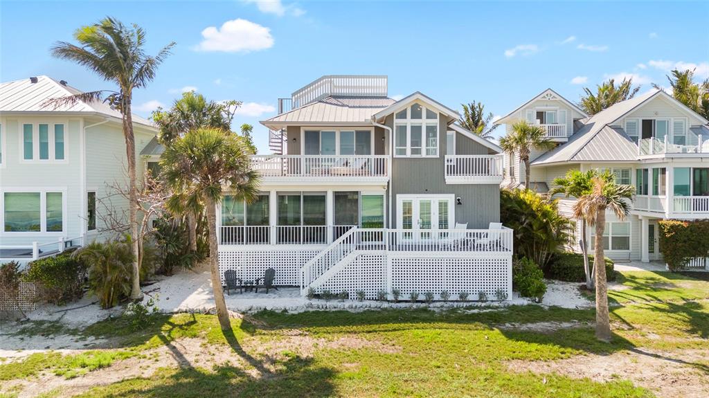 319 Pilot Point Lane Boca Grande, FL 33921 - Photo 48 of 62 a view of an house with swimming pool and porch