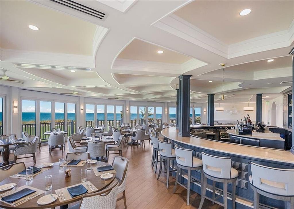 319 Pilot Point Lane Boca Grande, FL 33921 - Photo 60 of 62 a room with lots of tables a large window and chairs