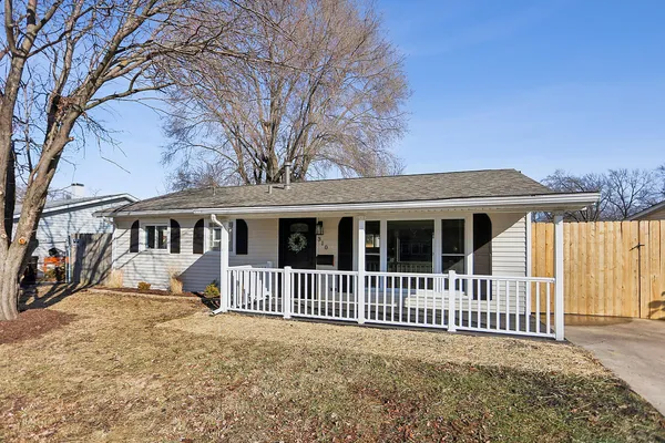 a view of a house with a yard next to a road