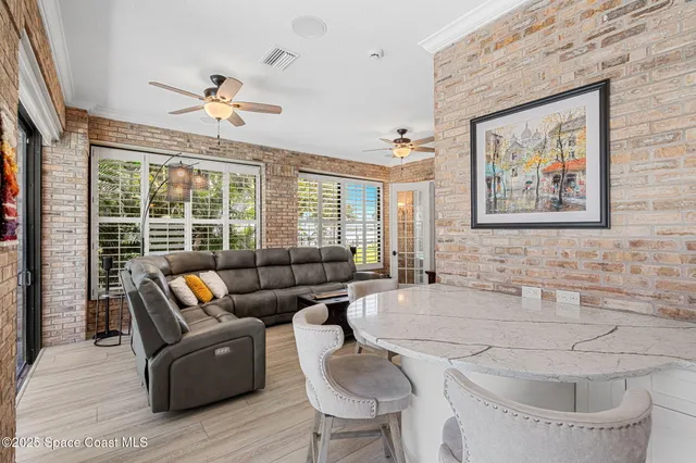 a kitchen that has a lot of cabinets in it and wooden floors