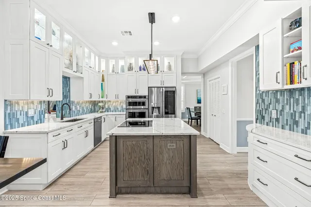 a kitchen with granite countertop a sink a stove and cabinets