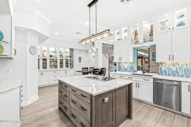 a spacious en suite bathroom with a granite countertop sink mirror and shower