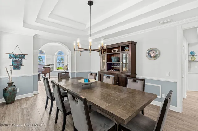 a view of a dining room with furniture and wooden floor