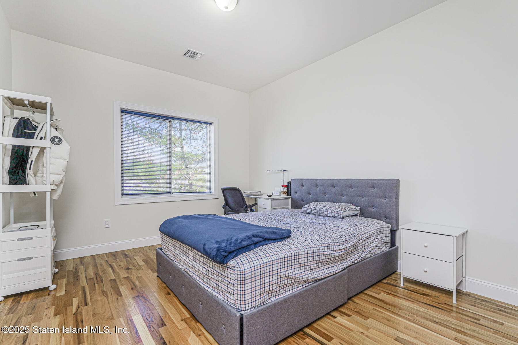 25 Ardmore Avenue Staten Island, NY 10314 - Photo 14 of 27 a bed sitting in a bedroom next to a window with a dresser