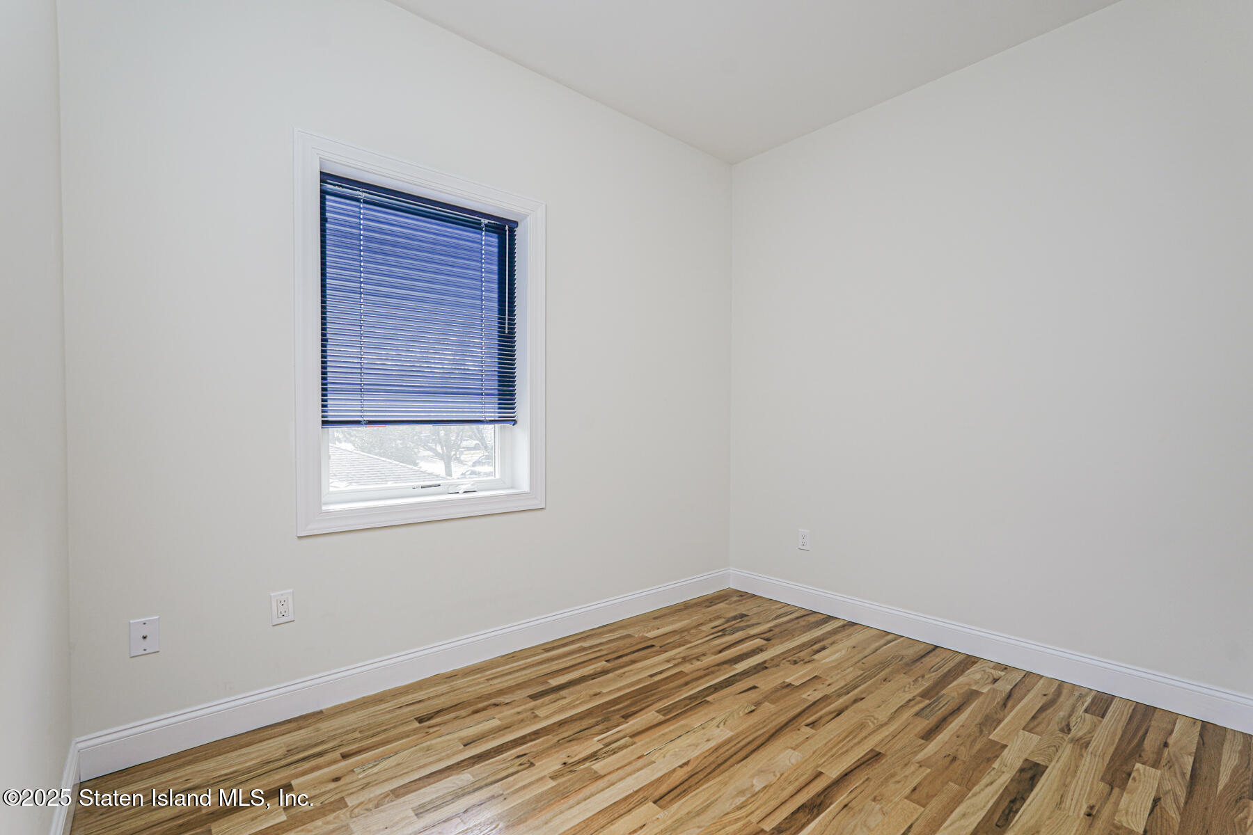 25 Ardmore Avenue Staten Island, NY 10314 - Photo 18 of 27 an empty room with wooden floor and windows