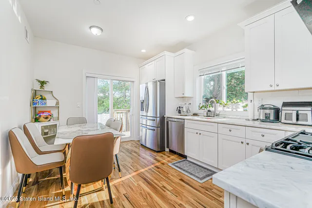 a kitchen with stainless steel appliances a stove a sink and a refrigerator
