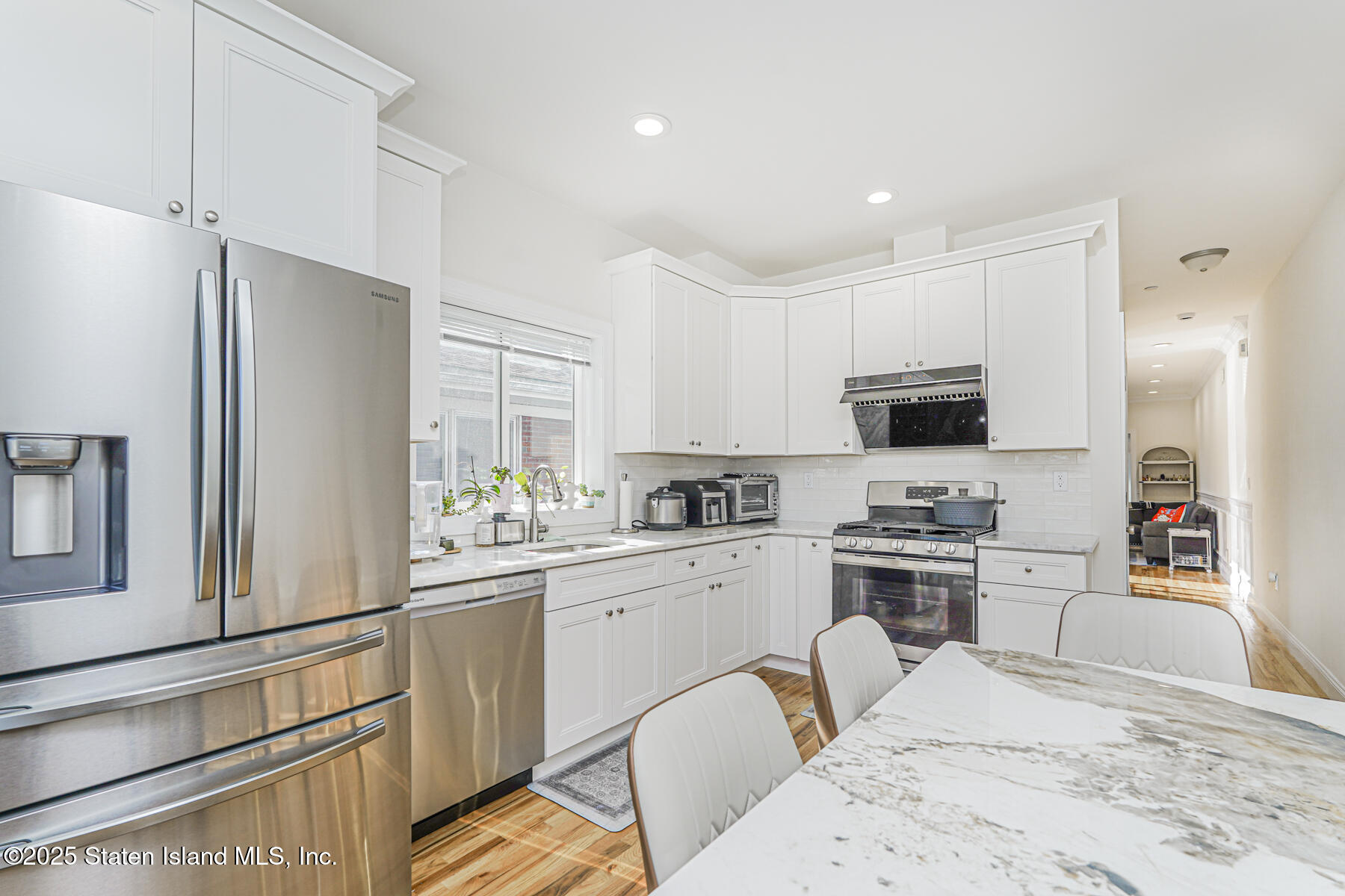 25 Ardmore Avenue Staten Island, NY 10314 - Photo 26 of 27 a kitchen with stainless steel appliances white cabinets a sink a stove a refrigerator and a refrigerator