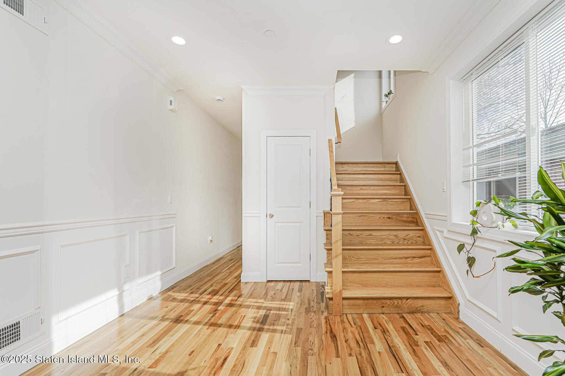 25 Ardmore Avenue Staten Island, NY 10314 - Photo 5 of 27 a view of a hallway with wooden floor and staircase