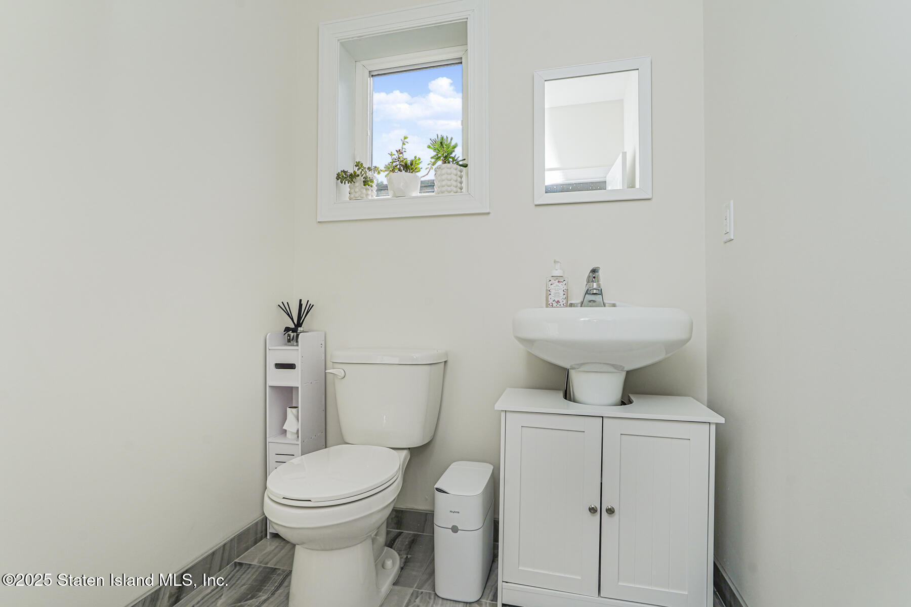 25 Ardmore Avenue Staten Island, NY 10314 - Photo 7 of 27 a bathroom with a toilet sink and mirror