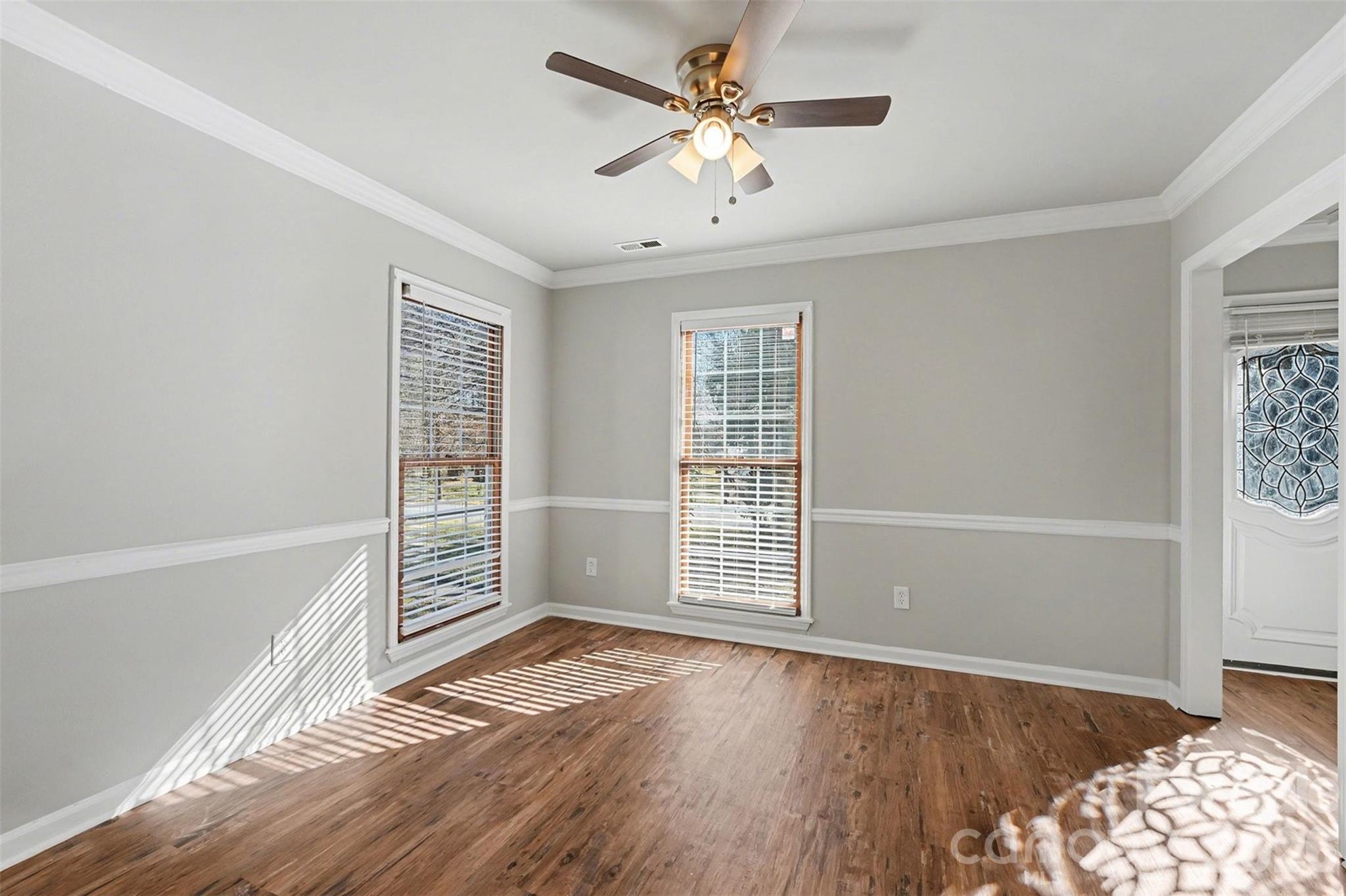 1635 Bear Mountain Road Charlotte, NC 28214 - Photo 12 of 27 an empty room with wooden floor and windows
