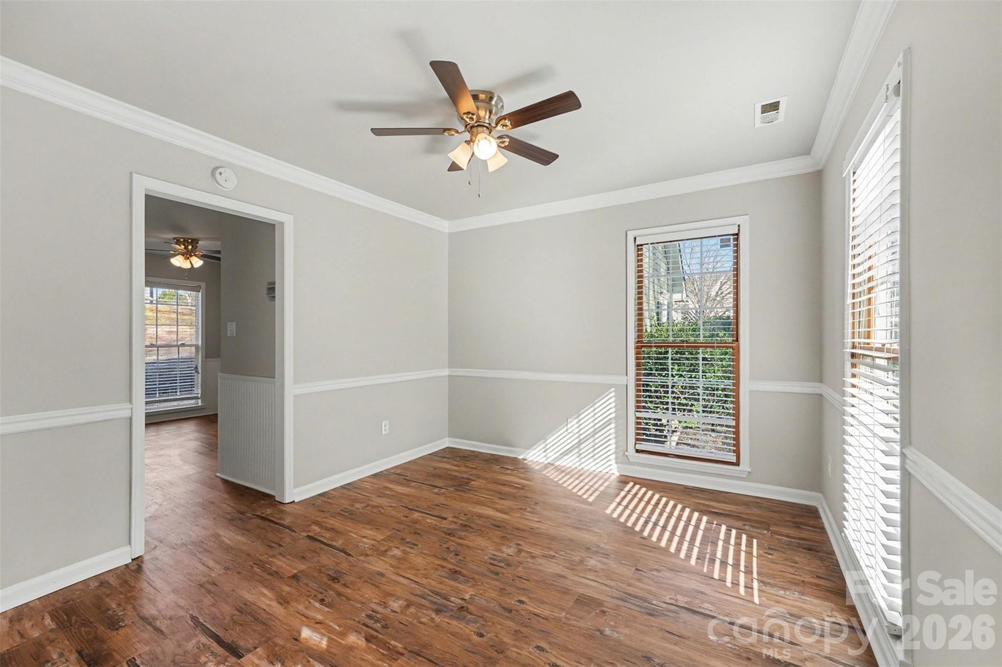 1635 Bear Mountain Road Charlotte, NC 28214 - Photo 13 of 27 an empty room with wooden floor fan and windows