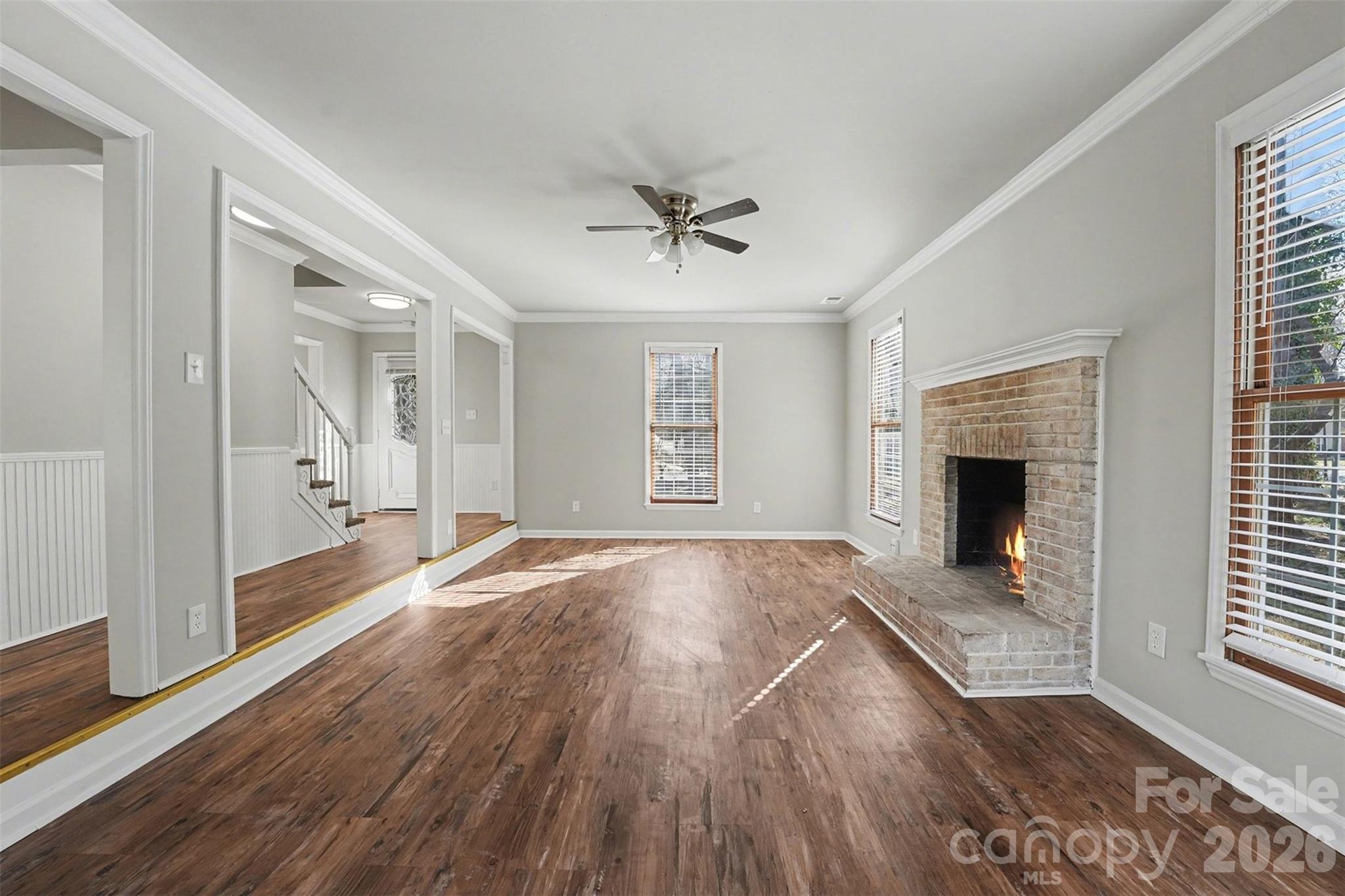 1635 Bear Mountain Road Charlotte, NC 28214 - Photo 14 of 27 an empty room with wooden floor and windows